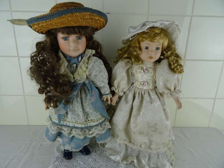 Twee vintage poppen met standaard